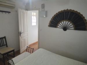 Habitación con cama y ventilador en la pared en atico centrico nervion, en Sevilla