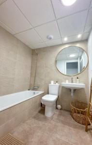a bathroom with a toilet and a sink and a mirror at OCEAN APARTAMENT !! 1ª Línea del Mar, piscina, parking, wifi in Mojácar