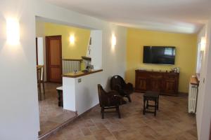 a living room with chairs and a flat screen tv at Villa Giuly in Antronapiana