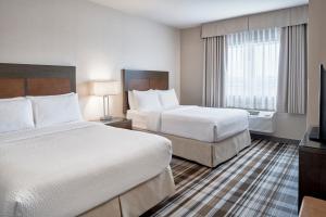 Postel nebo postele na pokoji v ubytování Fairfield Inn & Suites by Marriott Airdrie