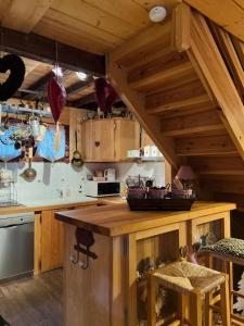 a kitchen with a wooden counter top in a room at Aux trois marmottes - Chalet au pied des pistes in Formiguères
