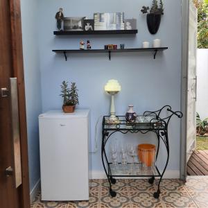 a table next to a wall with shelves at O Vilarejo - Lagoa da Conceição in Florianópolis +135 photos