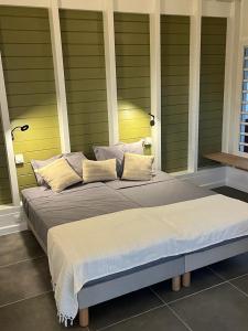 a large bed with two pillows on top of it at Villa Cajou chambres d'hôtes chez l'habitant et Zanzibar cottage in Trois-Rivières