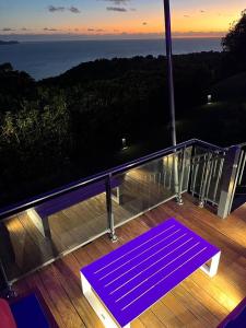 a purple yoga mat on a deck with a view of the ocean at Villa Cajou chambres d'hôtes chez l'habitant et Zanzibar cottage in Trois-Rivières