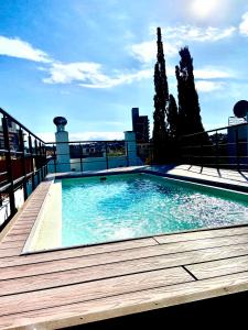 a swimming pool on the roof of a building at Dpto Edificio Tempo in Villa Carlos Paz +7 photos