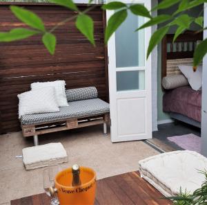 a patio with a door and a bench next to a porch at O Vilarejo - Lagoa da Conceição in Florianópolis