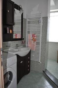 a bathroom with a sink and a washing machine at Vacanze Da Annalisa in Centola