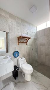 a bathroom with a toilet and a sink and a shower at Hotel Presidente Beach Playas in Playas