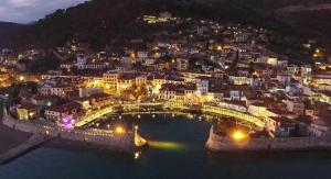 a city with a bridge over the water at night at DreamHouse in Nafpaktos