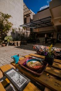 a wooden table with a bowl of food on it at Drop Inn Hostels in Colombo