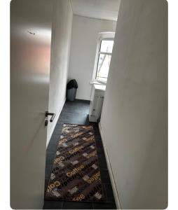 a hallway with a door and a rug on the floor at Best then hotel in Berlin
