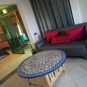 a living room with a couch and a table at فندق صنهاجة صفرو 