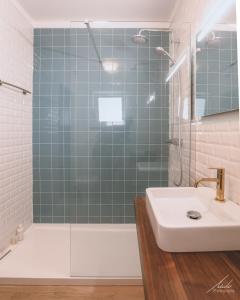 a bathroom with a shower and a sink and a tub at Guesthouse Beach Break in Peniche