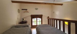 a living room with a staircase and a window at maison de vacances in Quend