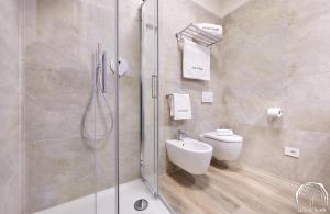 a bathroom with a shower and a toilet and a sink at FORESTERIA GUESTHOUSE CA' DEI BACHITT in Lierna