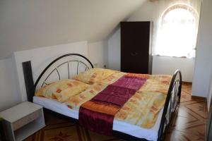 a bedroom with a bed with a quilt on it at Chalupa Ohře in Libochovice
