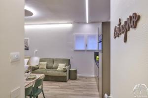 a living room with a couch and a table at FORESTERIA GUESTHOUSE CA' DEI BACHITT in Lierna