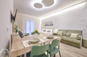 a dining room and living room with a table and chairs at FORESTERIA GUESTHOUSE CA' DEI BACHITT in Lierna