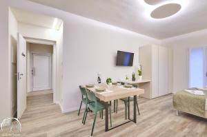 a dining room with a table and chairs and a bed at FORESTERIA GUESTHOUSE CA' DEI BACHITT in Lierna