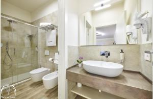 a bathroom with a sink and a shower and a toilet at FORESTERIA GUESTHOUSE CA' DEI BACHITT in Lierna