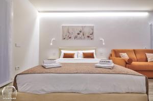 a bedroom with a large bed and a couch at FORESTERIA GUESTHOUSE CA' DEI BACHITT in Lierna