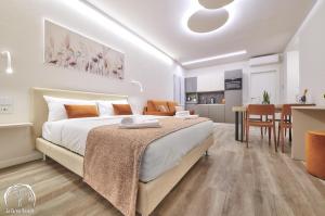 a bedroom with a large bed and a kitchen at FORESTERIA GUESTHOUSE CA' DEI BACHITT in Lierna