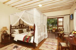 Een bed of bedden in een kamer bij Neptune Palm Beach Boutique Resort & Spa - All Inclusive
