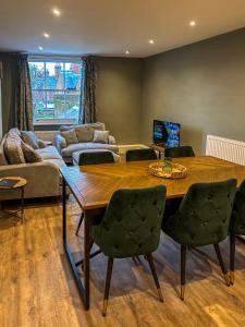 a living room with a wooden table and chairs at The Castle City Centre Apartment in Canterbury