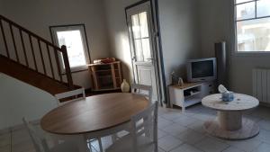 un salon avec une table et une télévision dans l'établissement Duplex avec 3 chambres à 30m de la plage, à Merlimont 21 autres photos