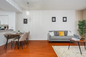 a living room with a couch and a table at Fort York Apartments in Toronto