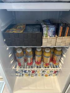 a refrigerator filled with lots of food and drinks at Complexe Dix80 in Mont-Laurier