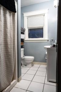 uma casa de banho branca com um WC e uma janela em Townhouse - Private 2nd Floor unit with Patio em Covington