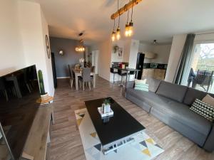 a living room with a couch and a table at LOVELY By Dream Apartments in Montévrain