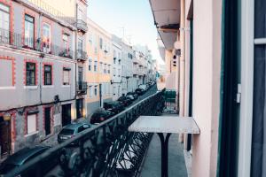 a view of a city street from a balcony at Guest House Arroios Rooms in Lisbon