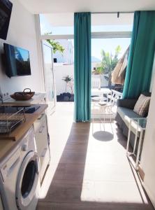 a living room with a washer and dryer at Paisaje Lunar in Tinajo