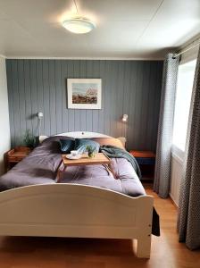 a bedroom with a bed with a table on it at Haukland Beach House in Leknes