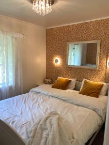 a bedroom with two beds and a mirror on the wall at Haukland Beach House in Leknes