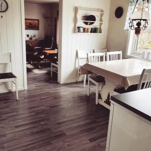 a kitchen with a table and a dining room at Haukland Beach House in Leknes