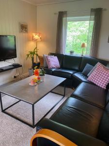 a living room with a couch and a coffee table at Haukland Beach House in Leknes