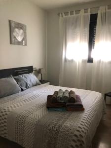 a bed with two pairs of shoes on it at Apartamento Migdia-Moraira in Moraira