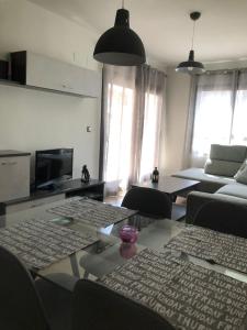 a living room with a couch and a table with chairs at Apartamento Migdia-Moraira in Moraira +40 photos
