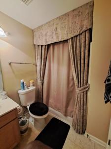 a bathroom with a toilet and a shower at Chiky Sanctuary in Raleigh