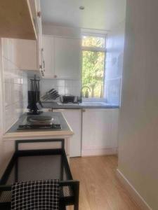 a small kitchen with a stove and a window at Flat in Kings Cross in London