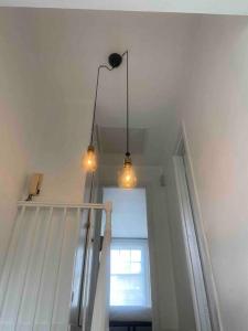 a staircase with two lights and a window at Flat in Kings Cross in London