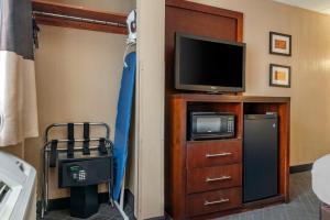 a room with a tv and a entertainment center with a tvictericter at Comfort Inn University in Amherst