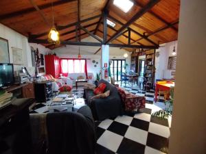 a living room with a couch and a table at Hostel Casa do Bolaxa in Rio Grande