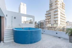 a blue tub on the roof of a building at Acacia Beautiful Studio in Buenos Aires