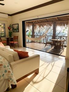 a living room with a couch and a patio at Paraiso Escondido Hotel Villas & Resort in El Níspero