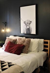 a bedroom with a picture of a cow on the wall at El Chuco Home W Pool, Pool Table,15 Min Downtown in El Paso