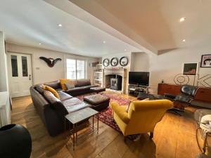 a living room with a couch and a fireplace at House by the sea in Kent